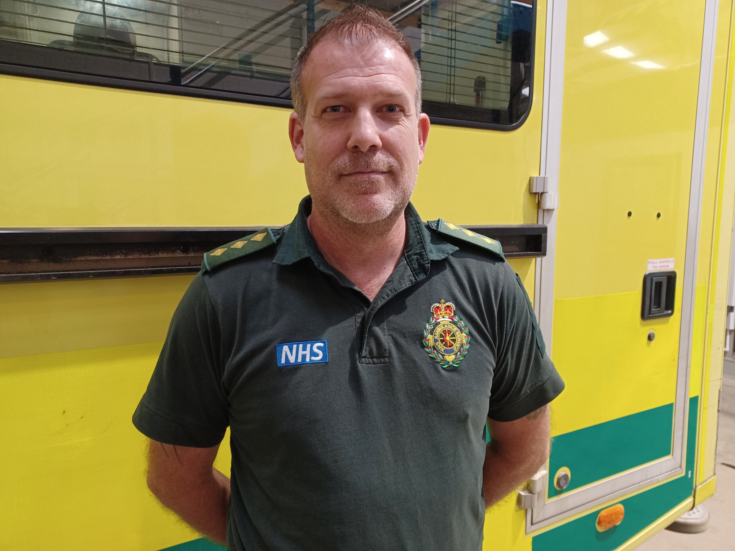 Paramedic standing in front of an ambulance