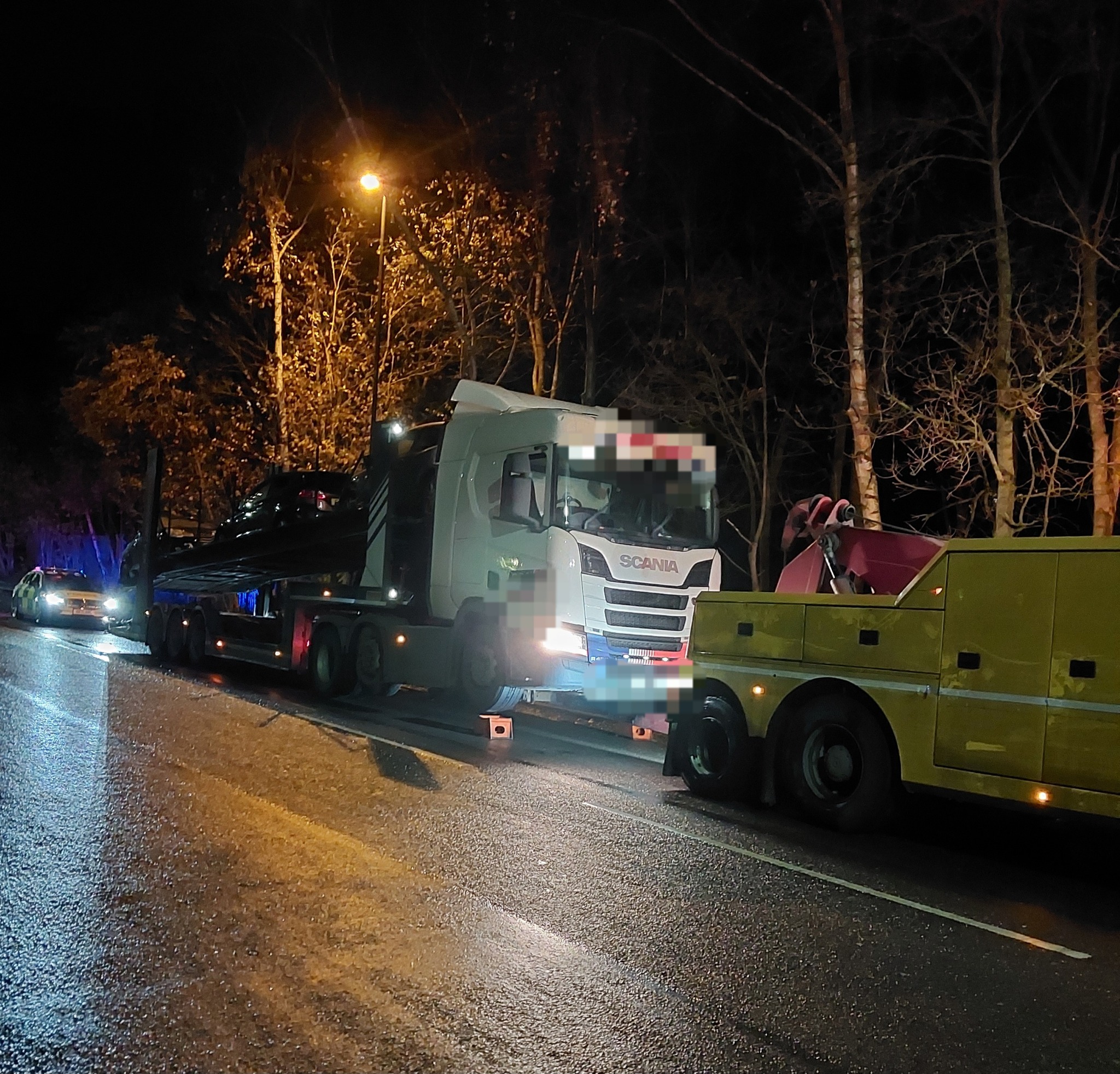 An HGV parked by the side of the road at night