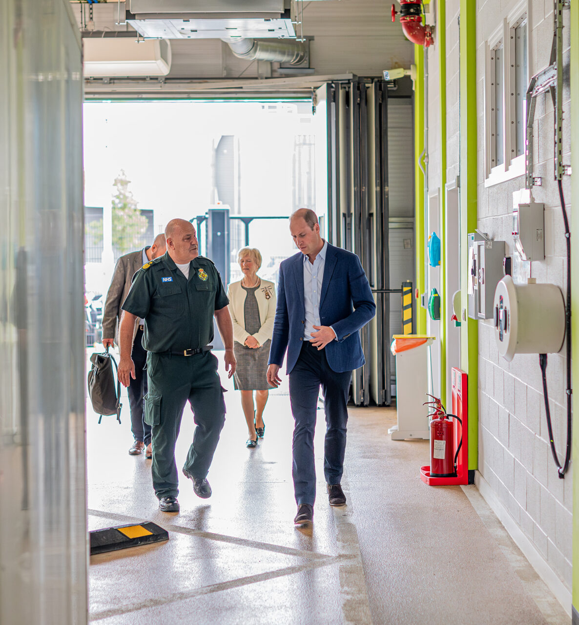 Prince William walking into an ambulance station with a paramedic